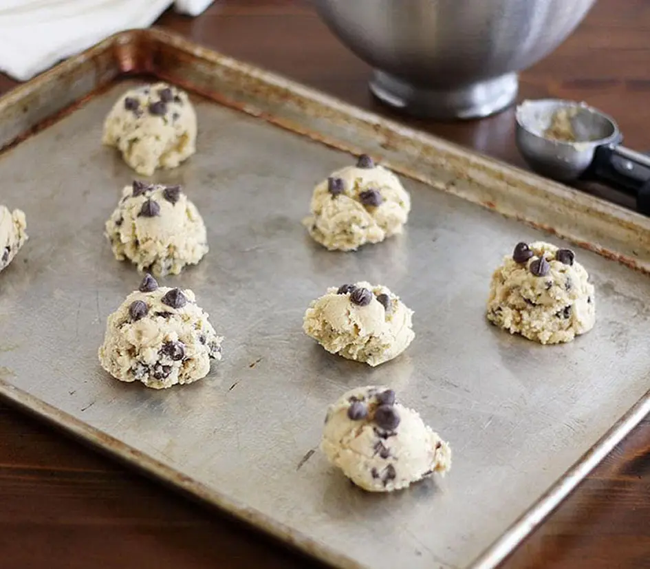 Baking process - Chocolate chip cookie dough on a baking sheet ready to be baked