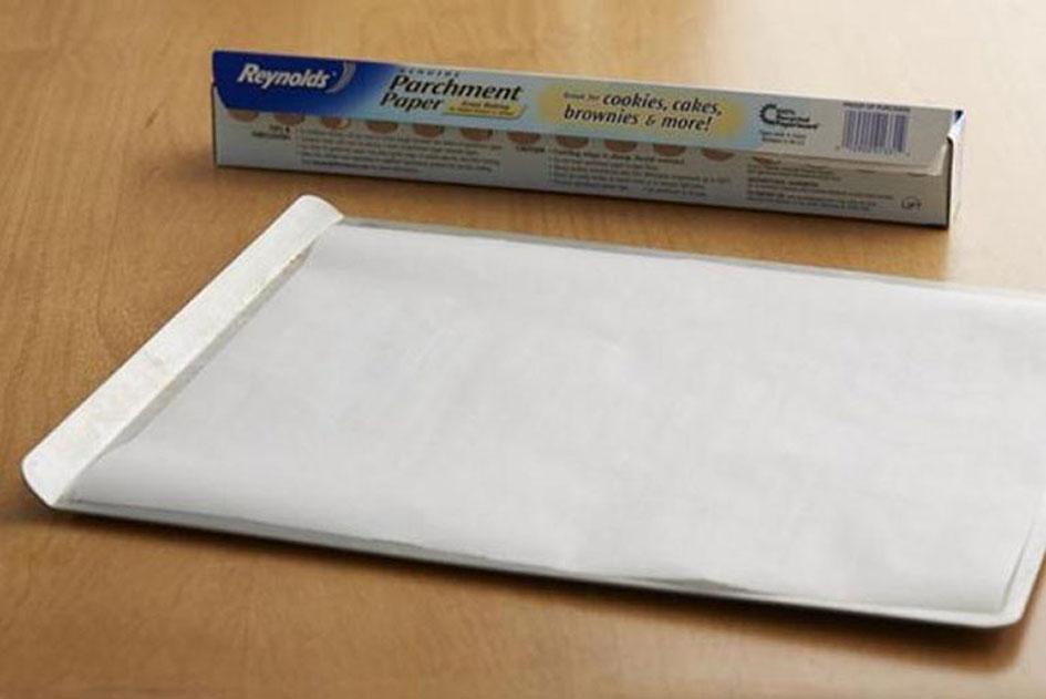 Placing parchment paper on a baking pan