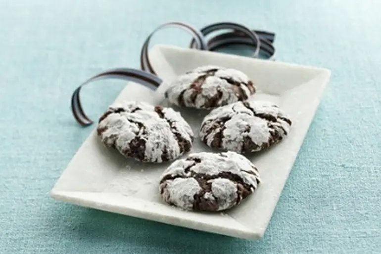 Frosted chocolate cookies on a square white plate