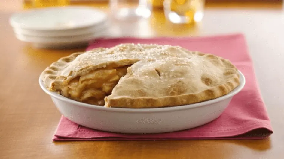 Two Crust Pie Pastry - An apple pie with a slice removed, showcasing golden crust and juicy apple filling