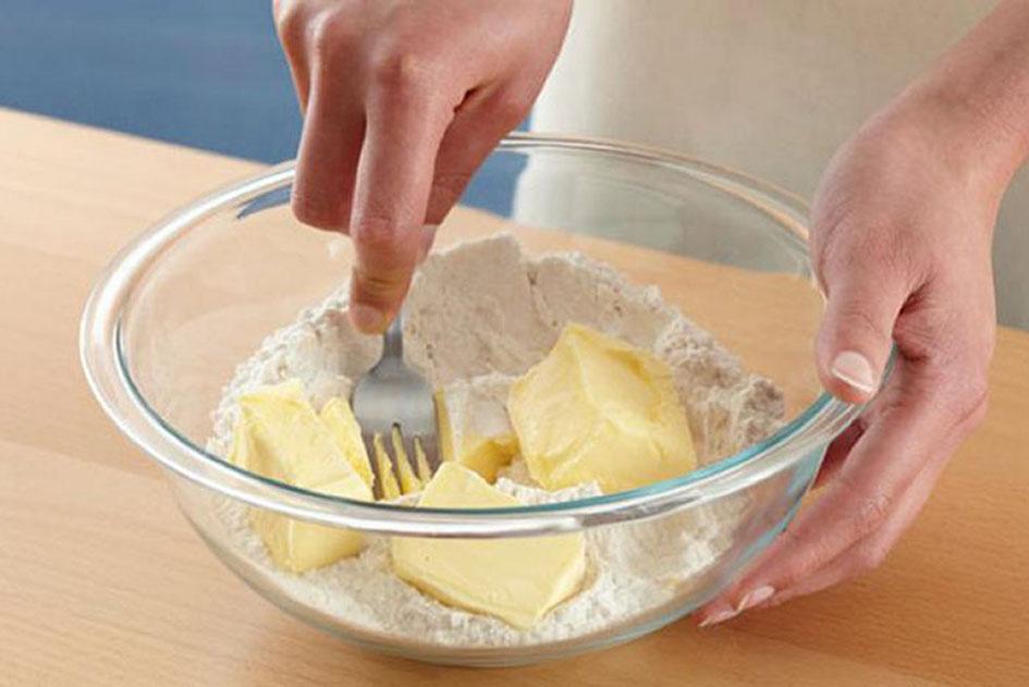 Mixing flour and butter to make a pastry