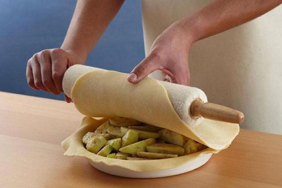 Hand placing pastry over filling.