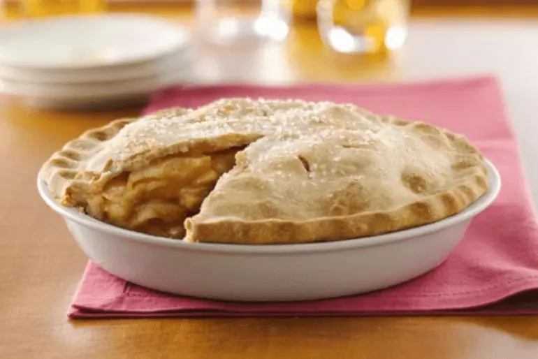 Two Crust Pie Pastry - An apple pie with a slice removed, showcasing golden crust and juicy apple filling