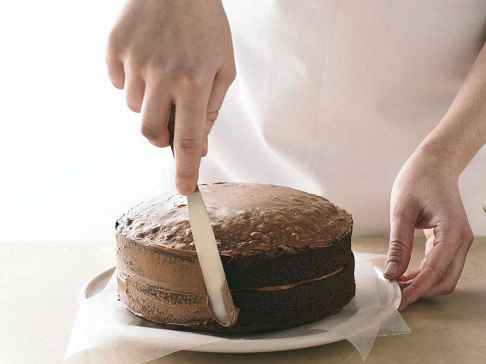 Tips for Making Cakes - Rounded side of second layer placed on first layer. Cake side coated with thin frosting layer to seal in crumbs